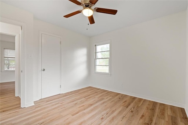 unfurnished bedroom with light hardwood / wood-style flooring, multiple windows, and ceiling fan