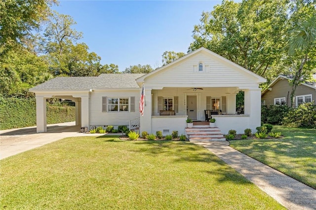 view of front of property with a porch, concrete driveway, crawl space, a carport, and a front yard