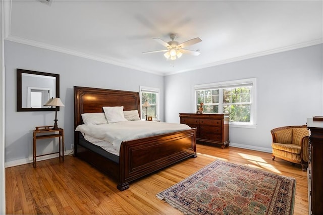 bedroom with light wood-style floors, multiple windows, and baseboards