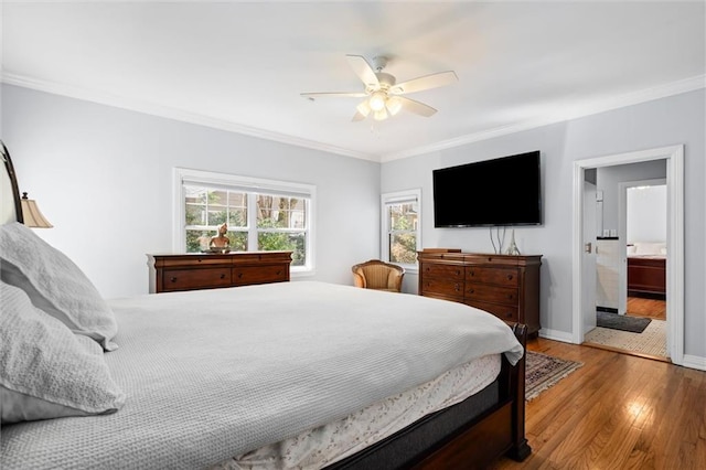 bedroom featuring baseboards, a ceiling fan, connected bathroom, ornamental molding, and wood finished floors