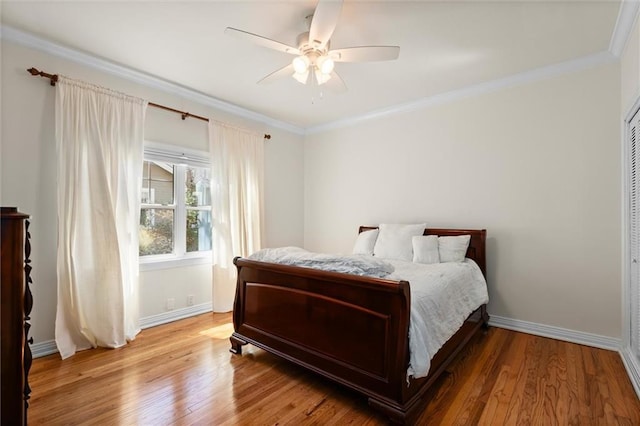 bedroom featuring baseboards, ornamental molding, ceiling fan, and wood finished floors