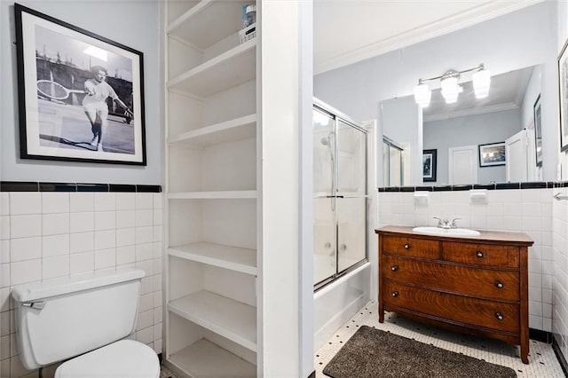 full bath with toilet, ornamental molding, tile walls, and vanity