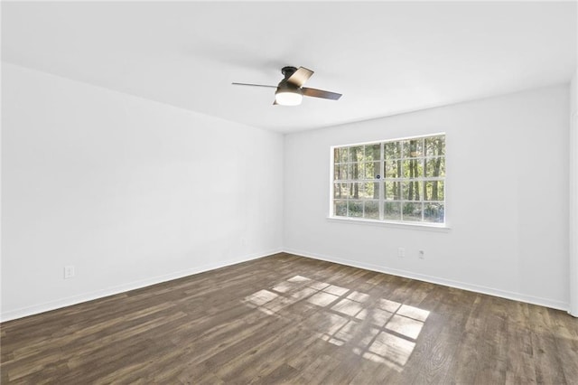 unfurnished room featuring ceiling fan and dark hardwood / wood-style flooring