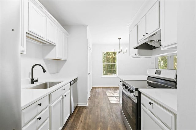 kitchen with stainless steel appliances, sink, decorative light fixtures, white cabinetry, and dark hardwood / wood-style flooring