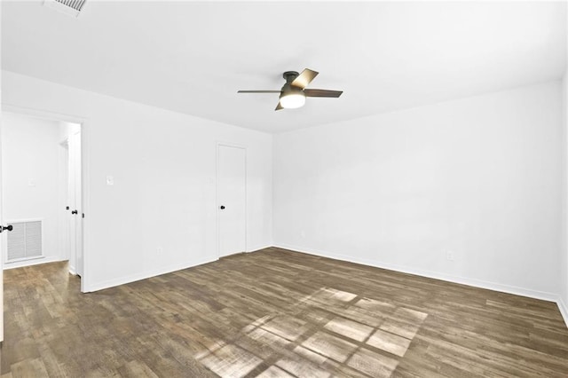 unfurnished room with dark hardwood / wood-style flooring and ceiling fan