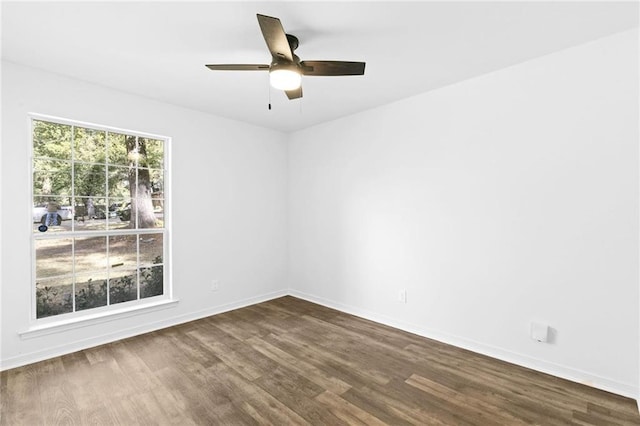 unfurnished room with ceiling fan and dark hardwood / wood-style flooring