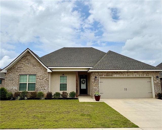 30768 Bauer Ave, Spanish Fort, AL 36527 - view of front facade featuring a garage, concrete driveway, a front yard, roof with shingles, and brick siding