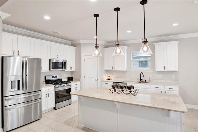 30768 Bauer Ave, Spanish Fort, AL 36527 - kitchen featuring appliances with stainless steel finishes, white cabinetry, a center island, ornamental molding, and pendant lighting