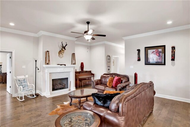 30768 Bauer Ave, Spanish Fort, AL 36527 - living area with wood finished floors, ceiling fan, recessed lighting, crown molding, and a fireplace with flush hearth