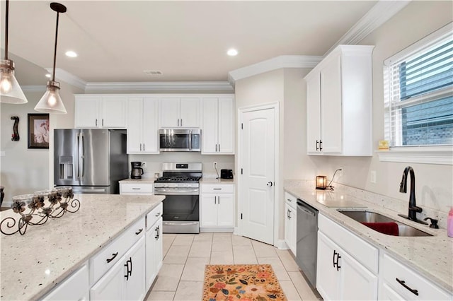 30768 Bauer Ave, Spanish Fort, AL 36527 - kitchen with stainless steel appliances, light tile patterned flooring, white cabinetry, crown molding, and light stone countertops