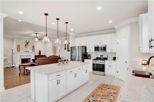 30768 Bauer Ave, Spanish Fort, AL 36527 - kitchen featuring appliances with stainless steel finishes, ornamental molding, a center island, light tile patterned flooring, and a ceiling fan