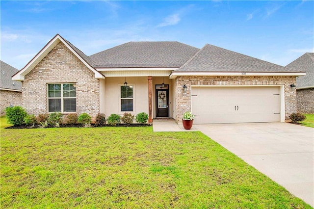 30768 Bauer Ave, Spanish Fort, AL 36527 - view of front of home featuring an attached garage, a front lawn, a shingled roof, driveway, and brick siding