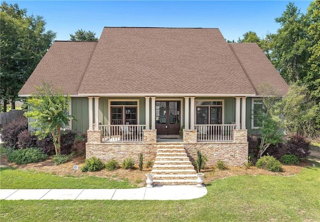 view of front of property with covered porch and a front lawn