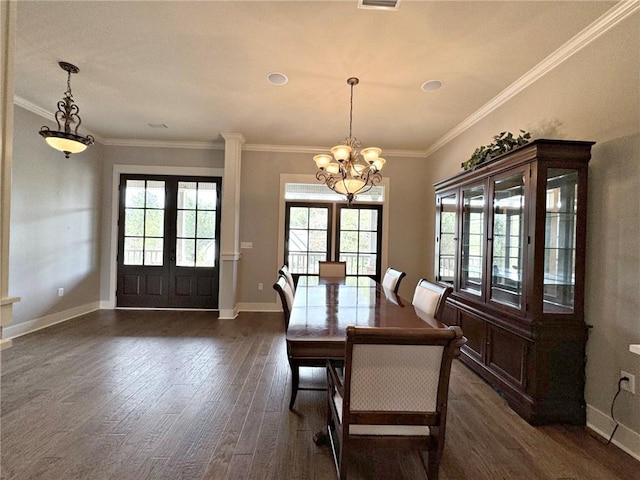 unfurnished dining area featuring dark hardwood / wood-style floors, an inviting chandelier, a healthy amount of sunlight, and crown molding