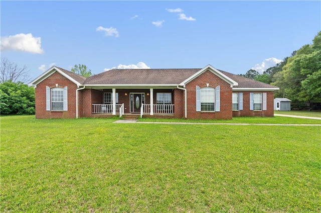 single story home featuring covered porch and a front yard