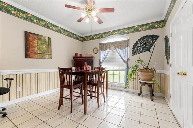 tiled dining space with crown molding, a textured ceiling, and ceiling fan