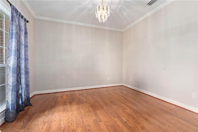 unfurnished room featuring crown molding, a notable chandelier, and wood-type flooring