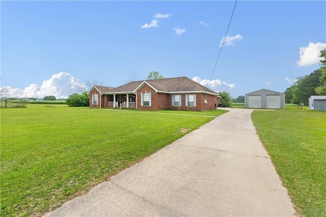 view of front of house featuring a front lawn, an outbuilding, and a garage