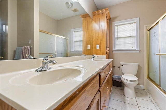 full bathroom featuring vanity, toilet, enclosed tub / shower combo, and tile patterned flooring