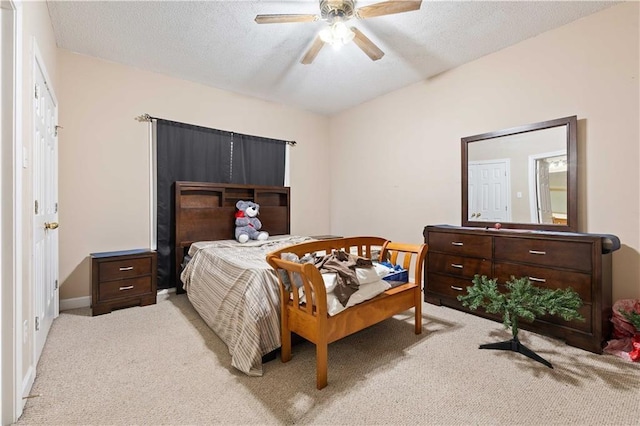 carpeted bedroom featuring a textured ceiling and ceiling fan