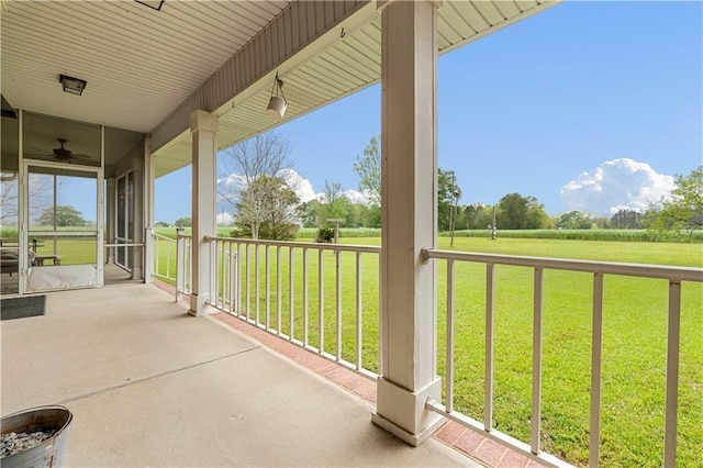 view of patio with ceiling fan and a porch