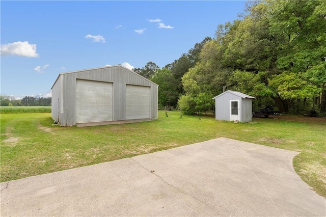 view of outdoor structure with a yard and a garage