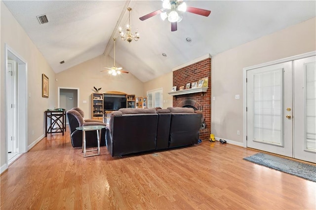 living room featuring beamed ceiling, a brick fireplace, light wood-type flooring, high vaulted ceiling, and ceiling fan