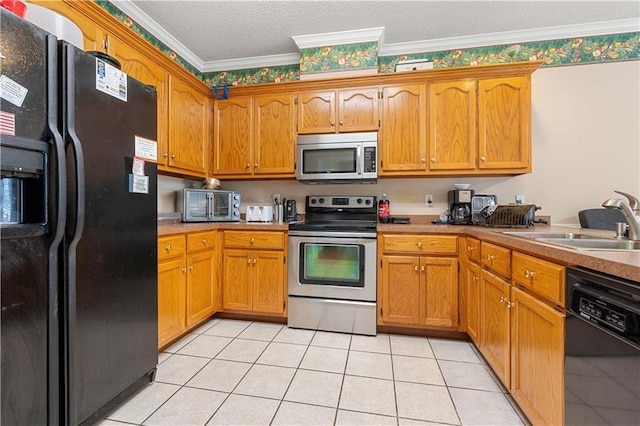 kitchen with a textured ceiling, ornamental molding, light tile patterned flooring, black appliances, and sink