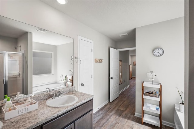 10232 Brodick Loop, Spanish Fort, AL 36527 - full bath featuring a shower stall, a bath, wood finished floors, baseboards, and vanity