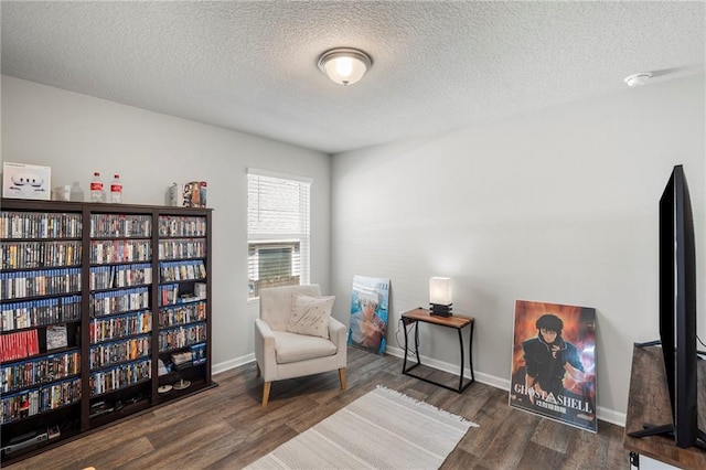 10232 Brodick Loop, Spanish Fort, AL 36527 - living area featuring a textured ceiling, wood finished floors, and baseboards
