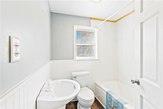 bathroom featuring toilet, bathtub / shower combination, and hardwood / wood-style floors