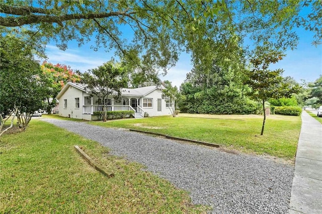 ranch-style house with a front lawn and a porch