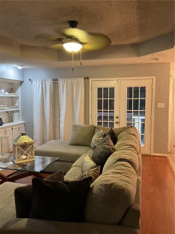 living room featuring french doors, a textured ceiling, and hardwood / wood-style flooring