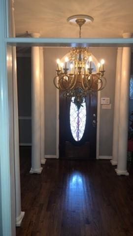 foyer featuring a notable chandelier and dark hardwood / wood-style flooring