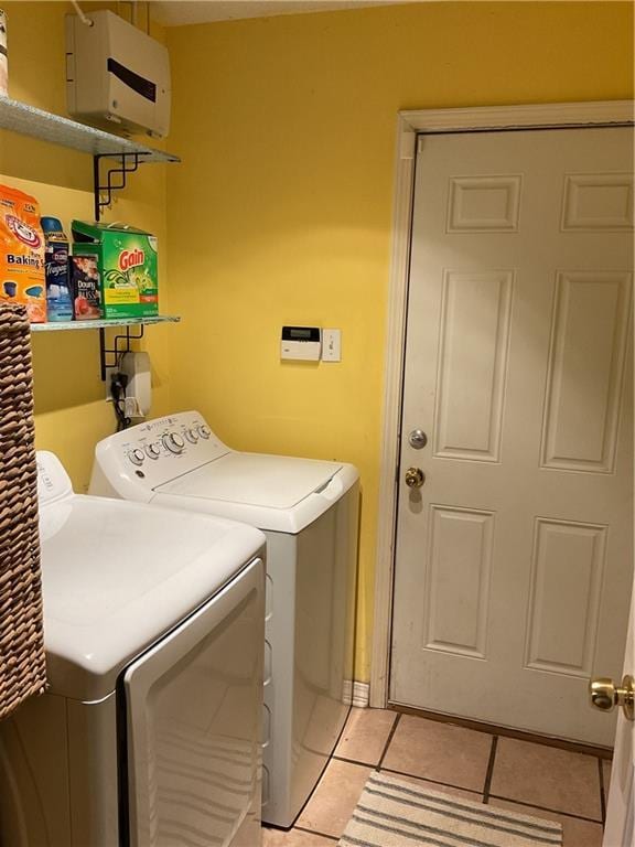 washroom featuring washer and dryer and light tile patterned floors