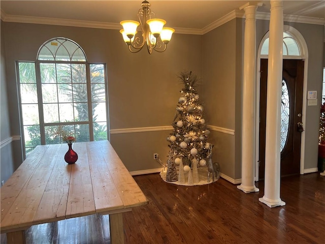 unfurnished dining area with an inviting chandelier, crown molding, dark wood-type flooring, and decorative columns