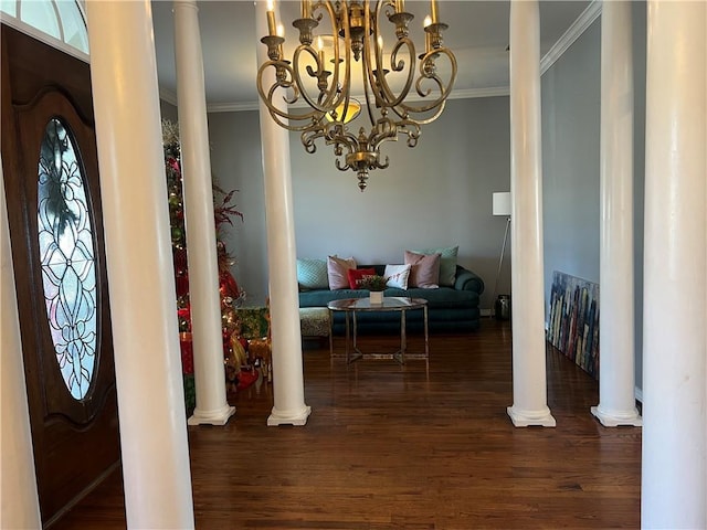 entryway featuring dark hardwood / wood-style flooring, decorative columns, and crown molding