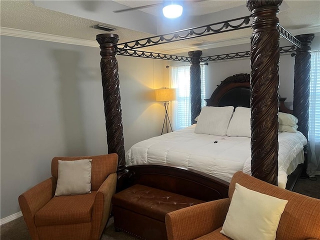 bedroom with carpet, a textured ceiling, ceiling fan, and crown molding