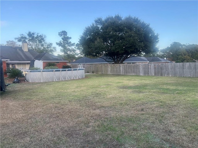 view of yard with a fenced in pool