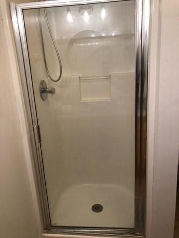 bathroom with a shower with door