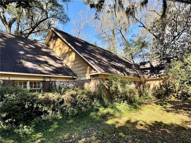 view of side of property featuring brick siding