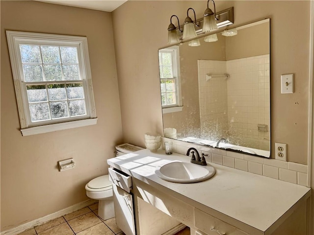 full bathroom featuring a shower, toilet, vanity, tile patterned flooring, and baseboards