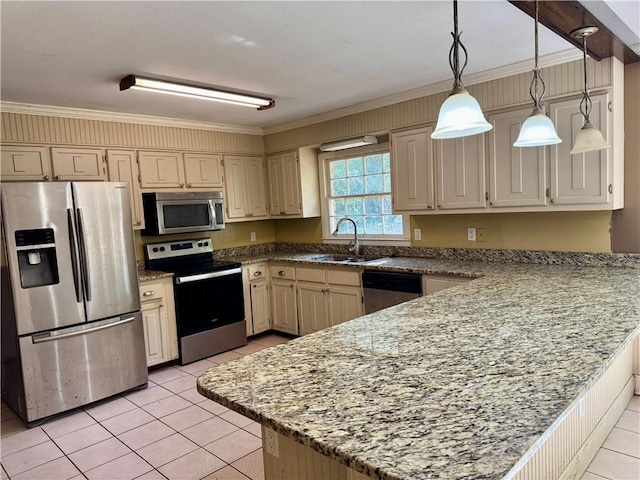 kitchen with light tile patterned floors, appliances with stainless steel finishes, a peninsula, hanging light fixtures, and a sink