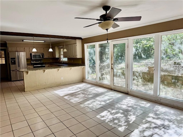 kitchen with stainless steel appliances, a peninsula, hanging light fixtures, a kitchen bar, and crown molding