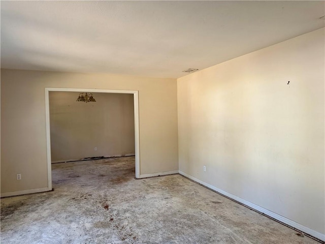 unfurnished room featuring visible vents and baseboards