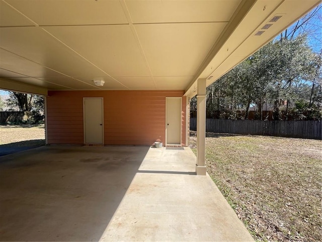 view of patio with fence and a carport