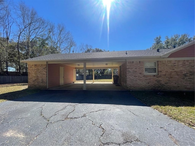 garage featuring a carport and driveway