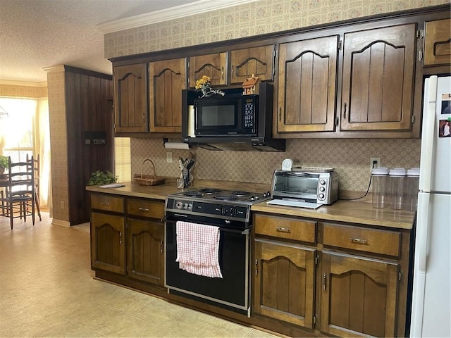 kitchen featuring a toaster, ornamental molding, light countertops, a textured ceiling, and black appliances