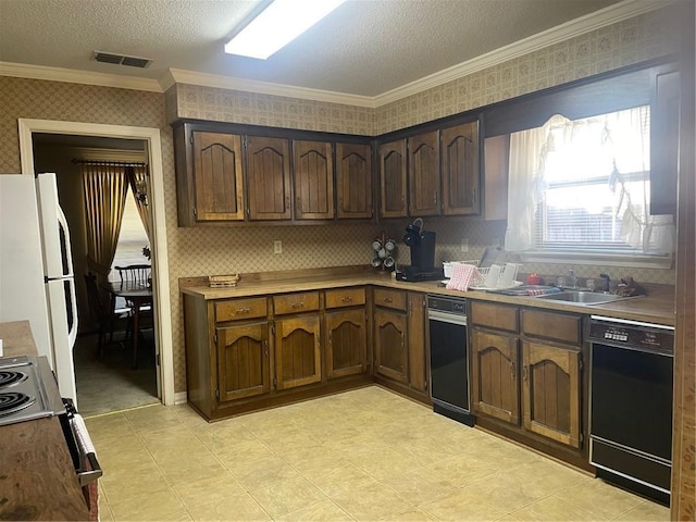 kitchen featuring wallpapered walls, black dishwasher, visible vents, freestanding refrigerator, and a sink