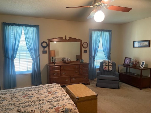 bedroom featuring light colored carpet and ceiling fan